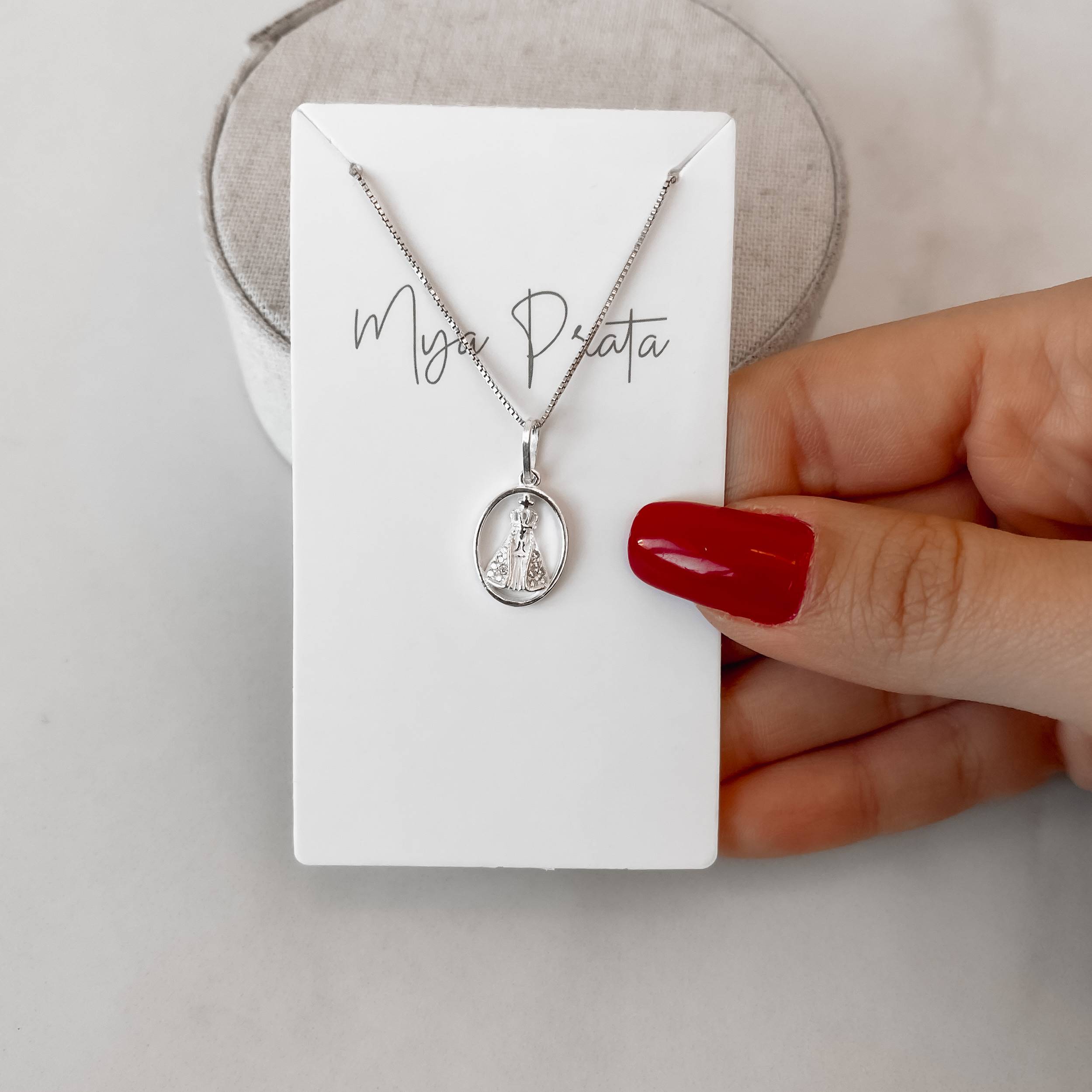 Imagem Secundária Colar pingente Nsa. Sra. Aparecida oval cravejada 14mm 45cm