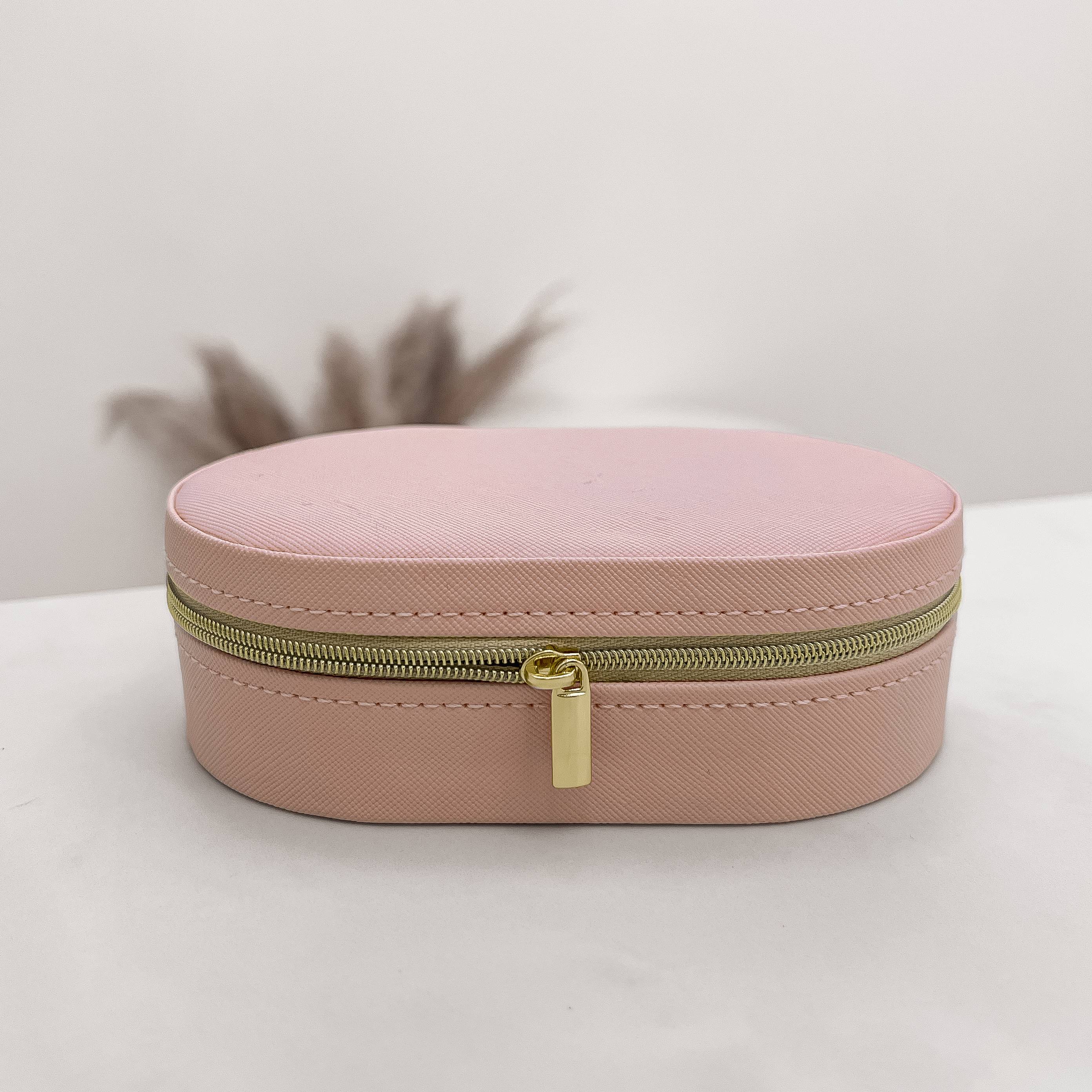 Porta-joias oval rosa 14x9x4cm zíper dourado