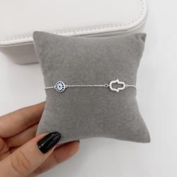 Pulseira entremeios mão vazada e olho grego cravejados 